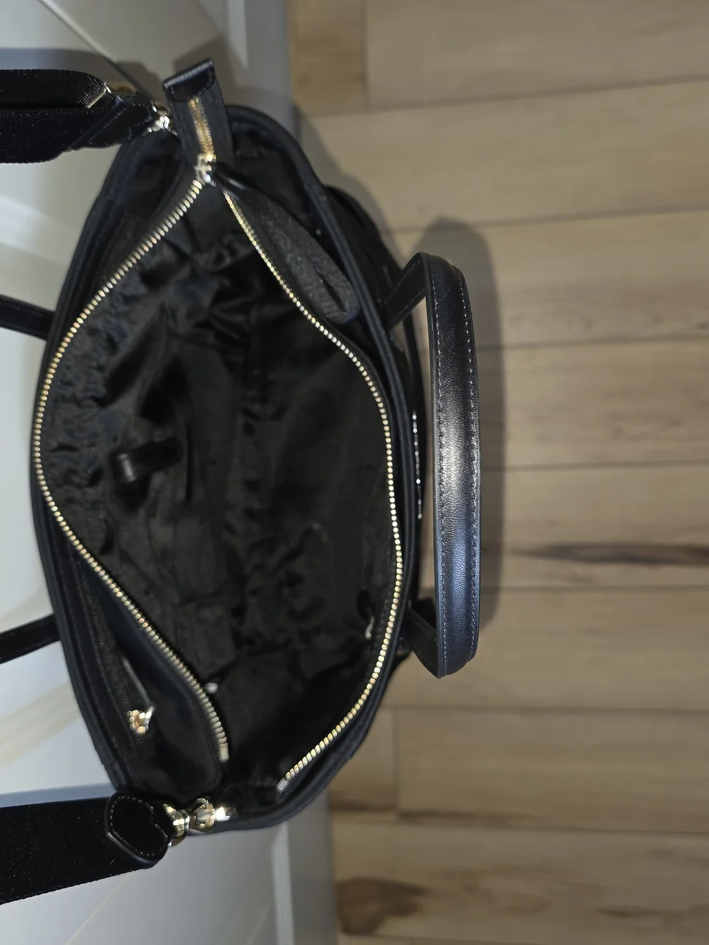 kate spade black tote with gold-tone logo and zipper